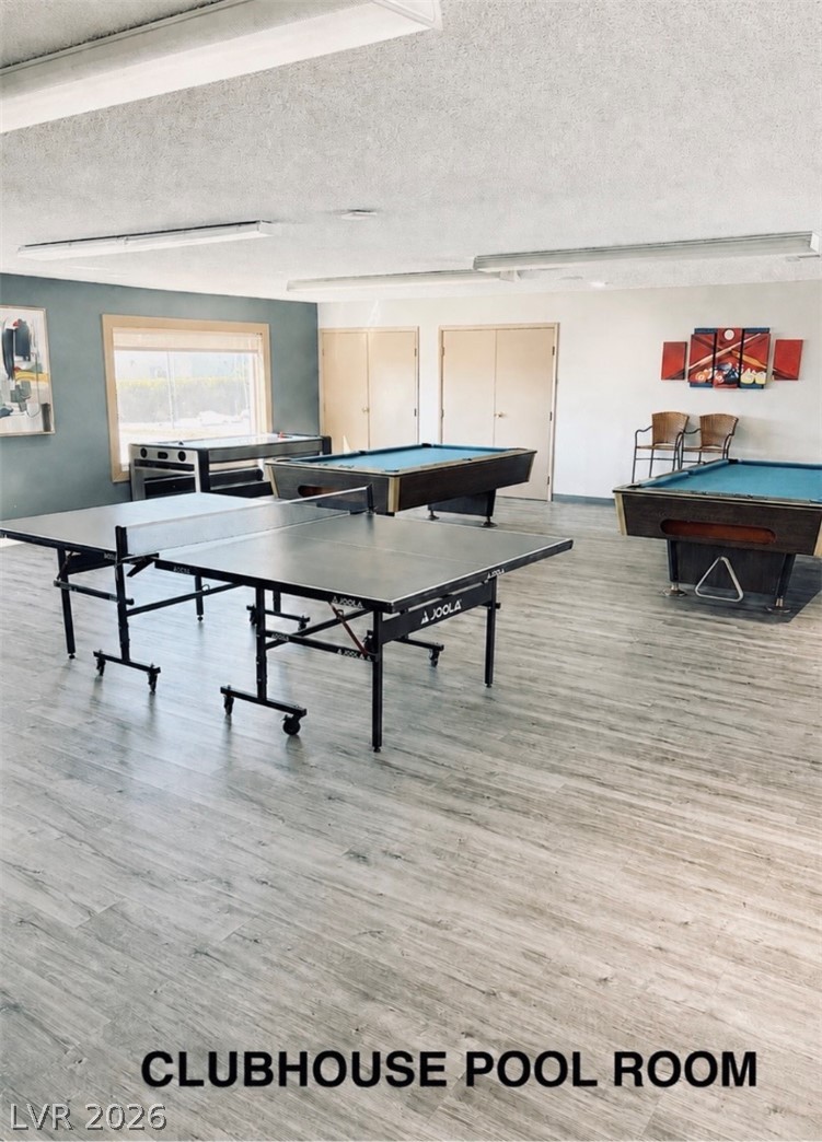4556 Royal Ridge Way Las Vegas, NV 89103 - Photo 33 of 49 Durable wood-look plank flooring anchors a spacious recreation space equipped for indoor entertainment.