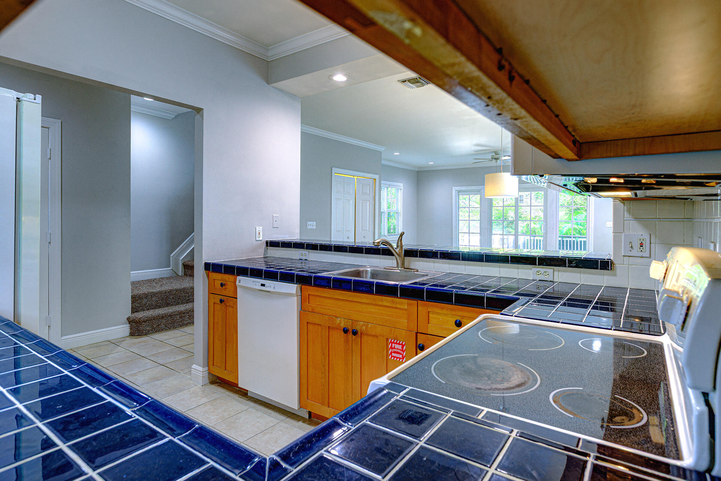 263 Golf Club Drive Key West, FL 33040 - Photo 5 of 30 a kitchen with stainless steel appliances granite countertop a stove a sink and a microwave
