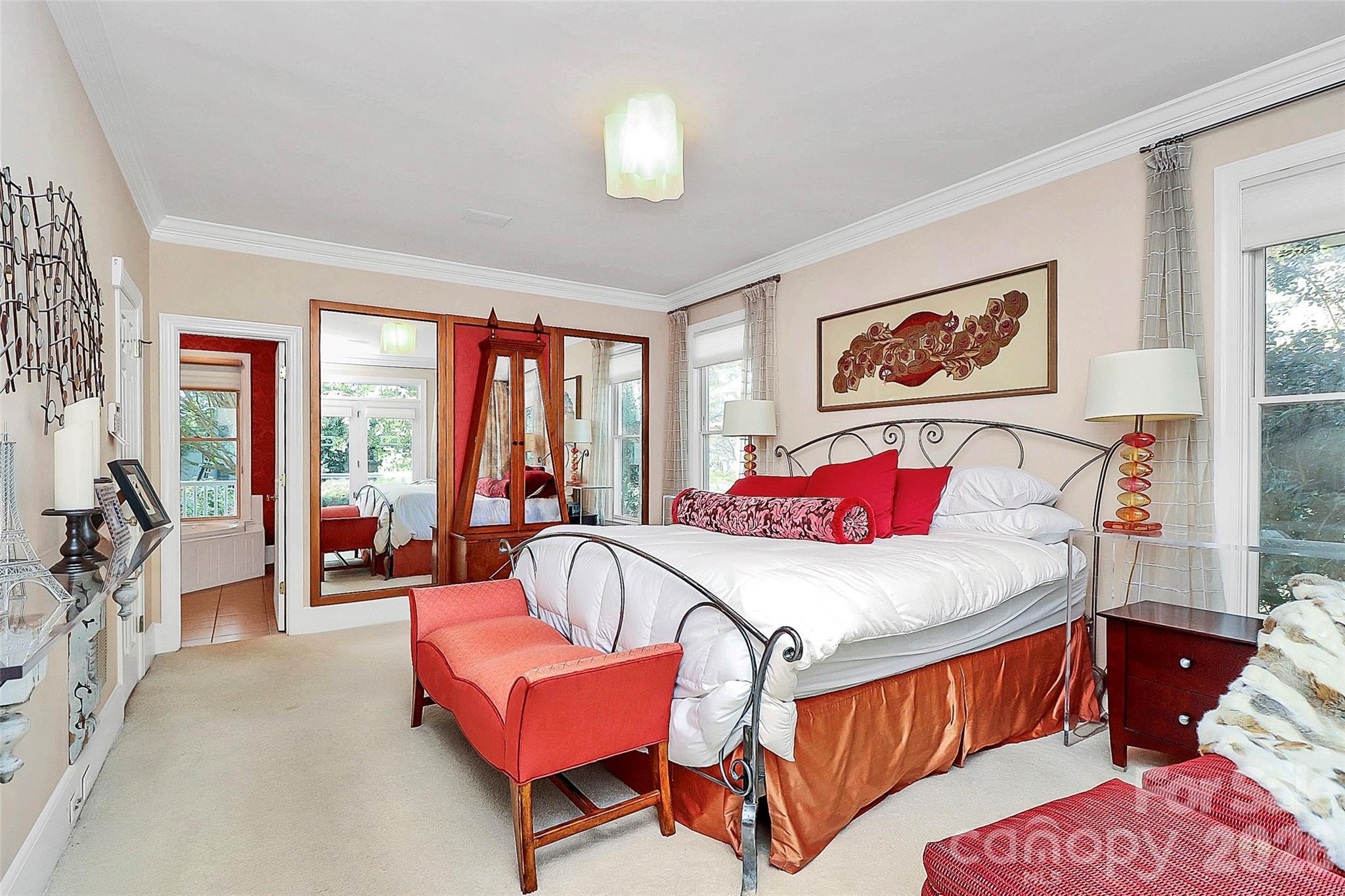 304 South Canterbury Road Charlotte, NC 28211 - Photo 17 of 39 a bedroom with a bed and a chandelier