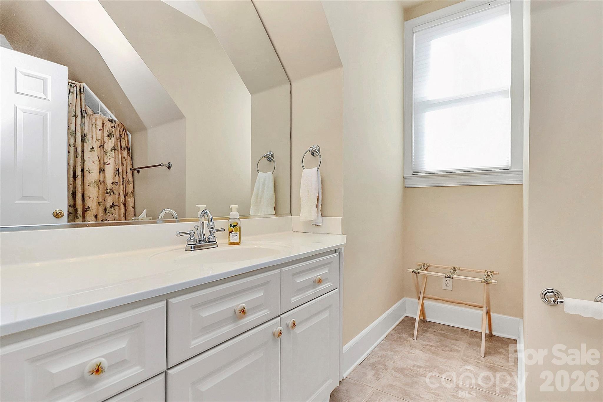 304 South Canterbury Road Charlotte, NC 28211 - Photo 26 of 39 a spacious bathroom with a sink and a mirror