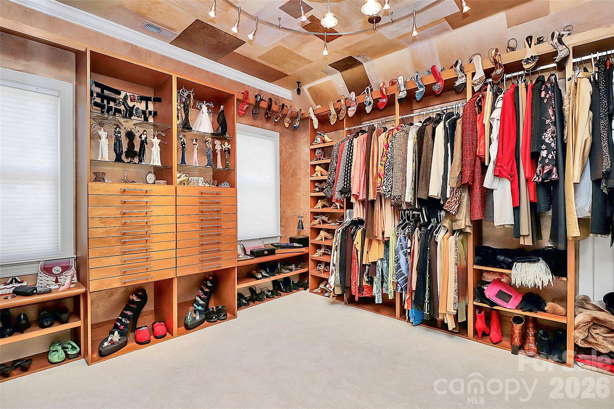 304 South Canterbury Road Charlotte, NC 28211 - Photo 27 of 39 a view of walk in closet with clothes and shoes