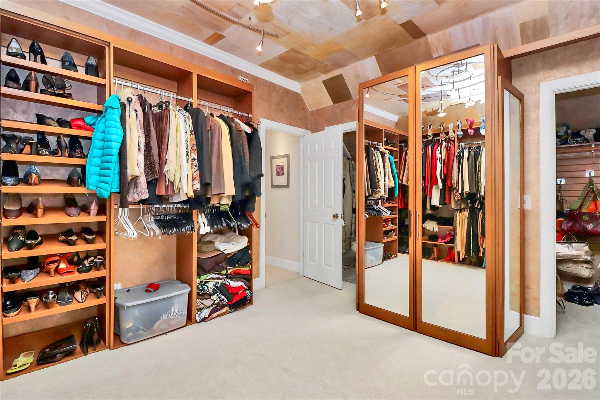 304 South Canterbury Road Charlotte, NC 28211 - Photo 28 of 39 a view of walk in closet with clothes and shoes