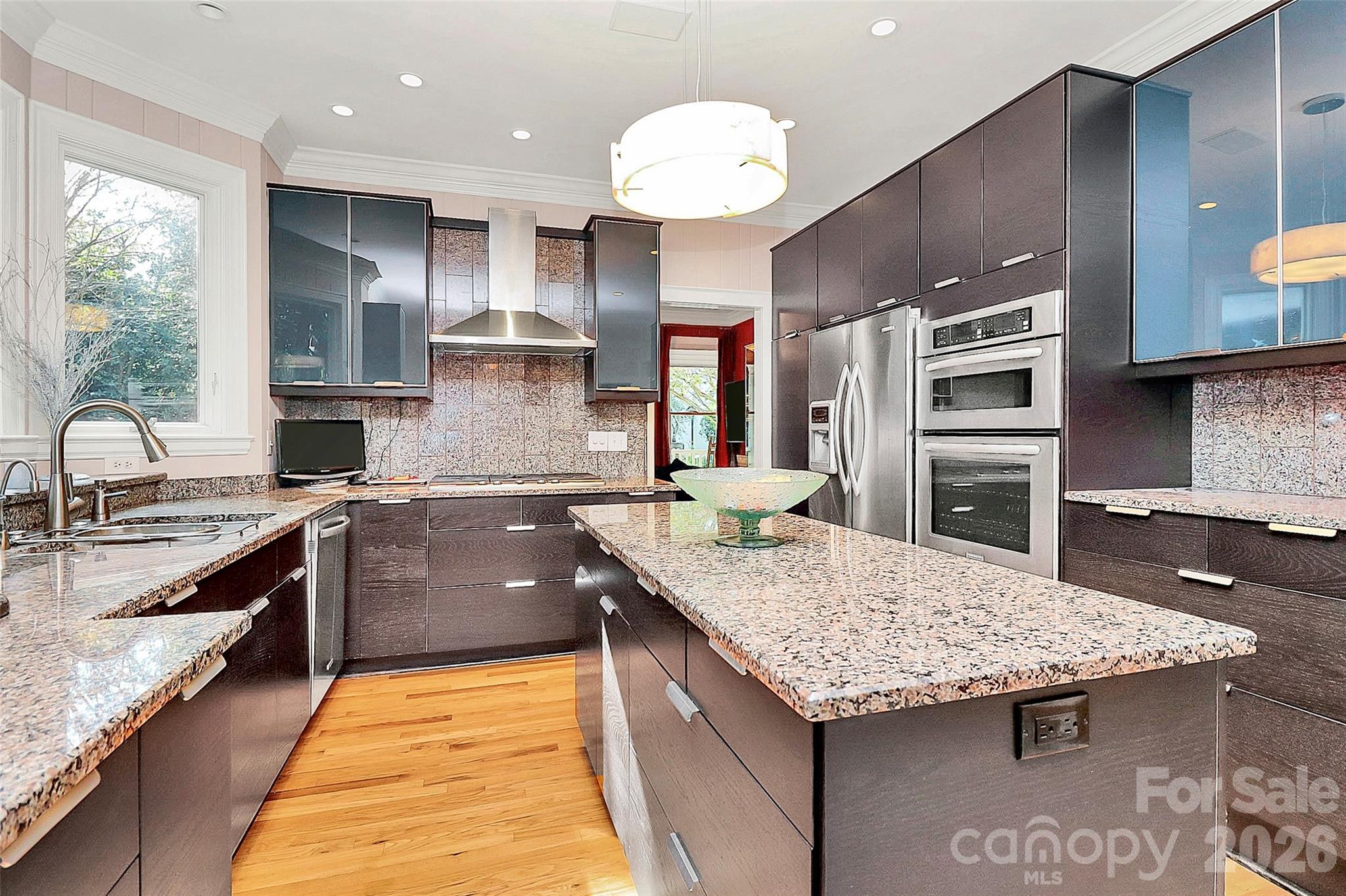 304 South Canterbury Road Charlotte, NC 28211 - Photo 6 of 39 a kitchen with granite countertop kitchen island stainless steel appliances a sink stove and cabinets