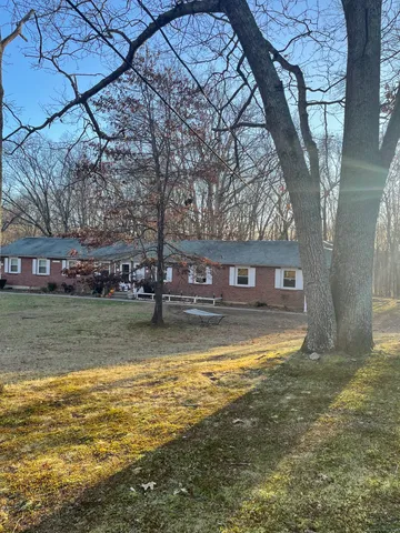 a view of pool and trees in the background