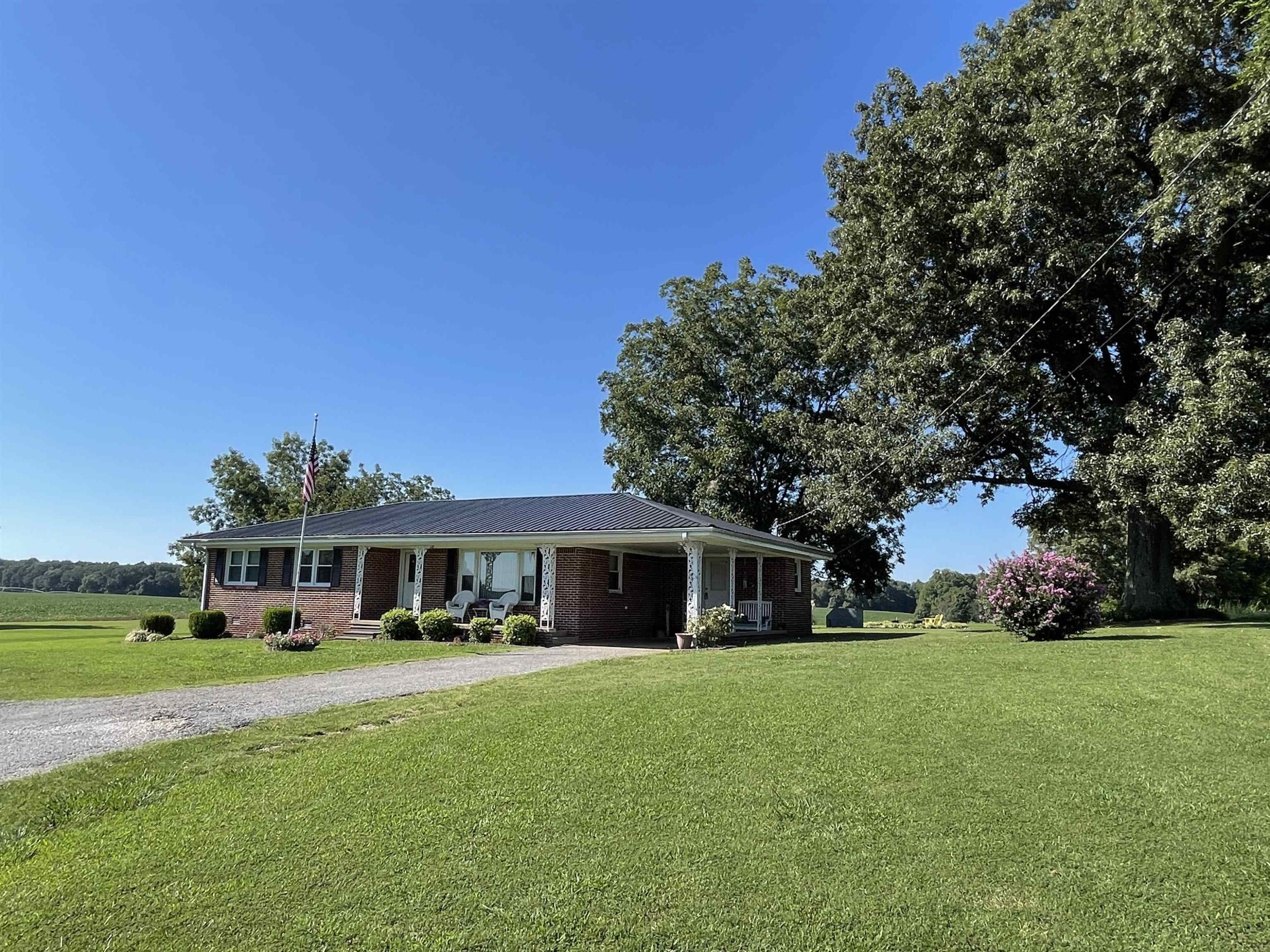 a front view of house with yard and green space