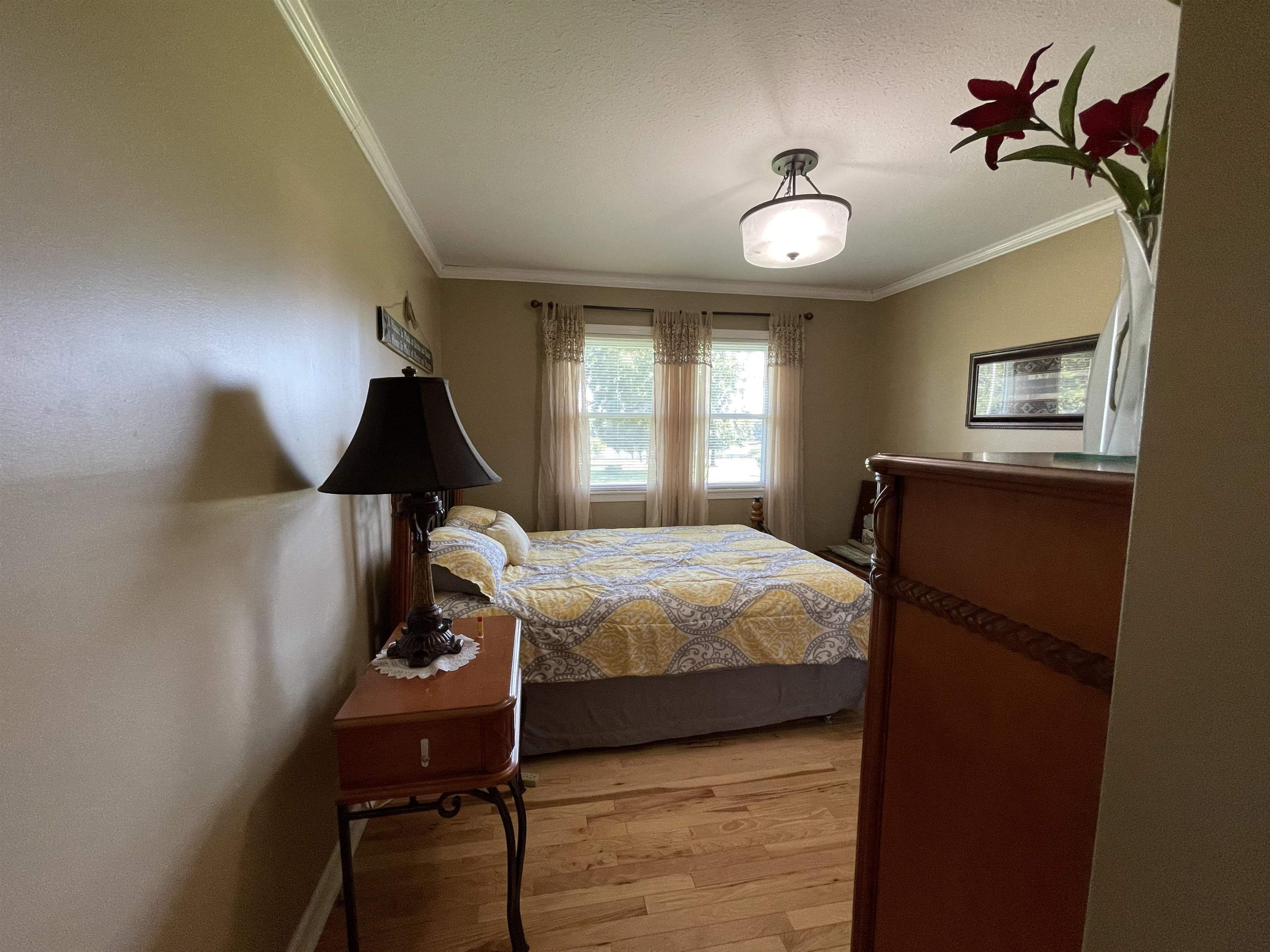 2507 East Grove Road Gleason, TN 38229 - Photo 13 of 37 a bedroom with a bed and a chandelier