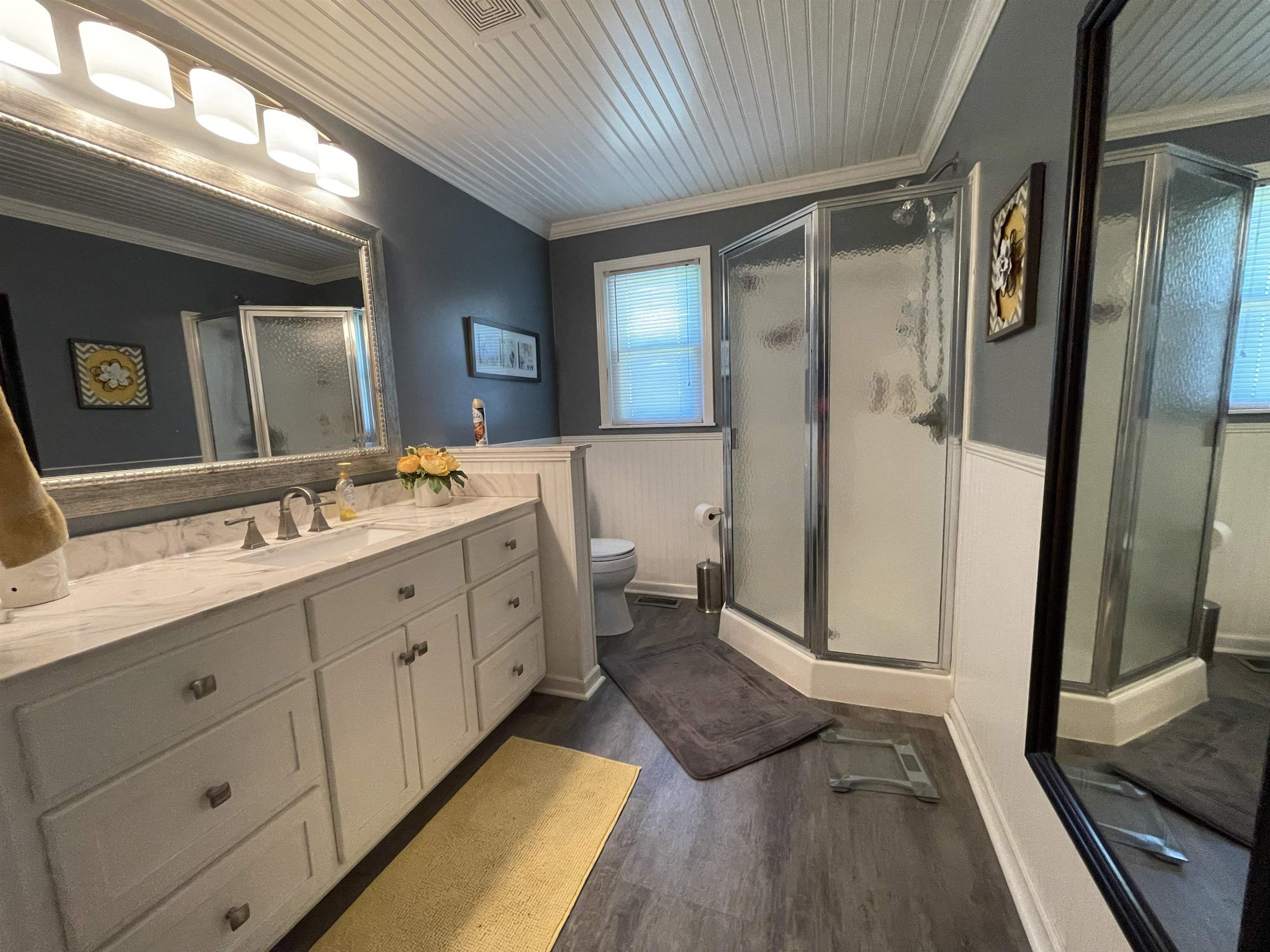 2507 East Grove Road Gleason, TN 38229 - Photo 16 of 37 a spacious bathroom with a double vanity sink a large mirror a shower and vanity