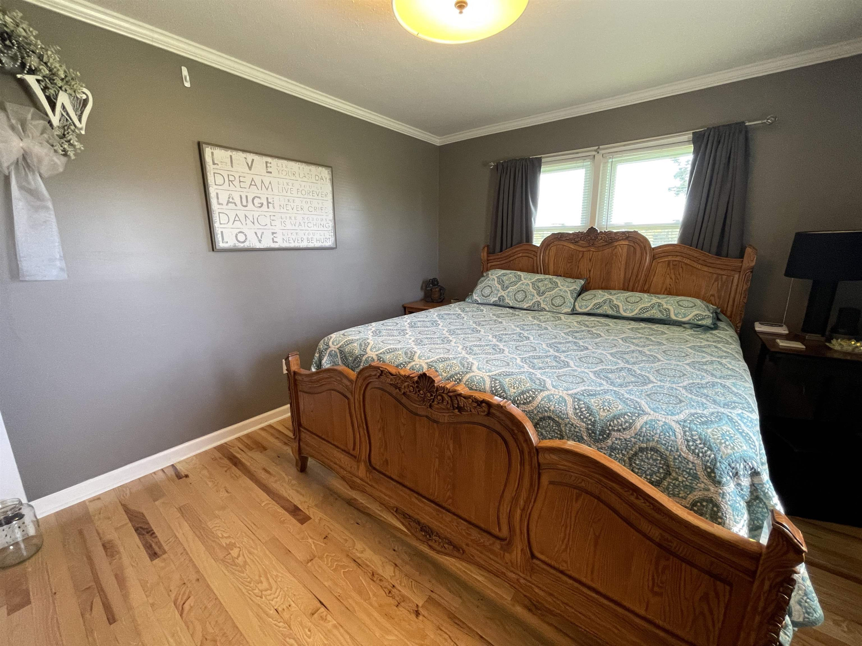 2507 East Grove Road Gleason, TN 38229 - Photo 19 of 37 a bed sitting in a bedroom next to a window