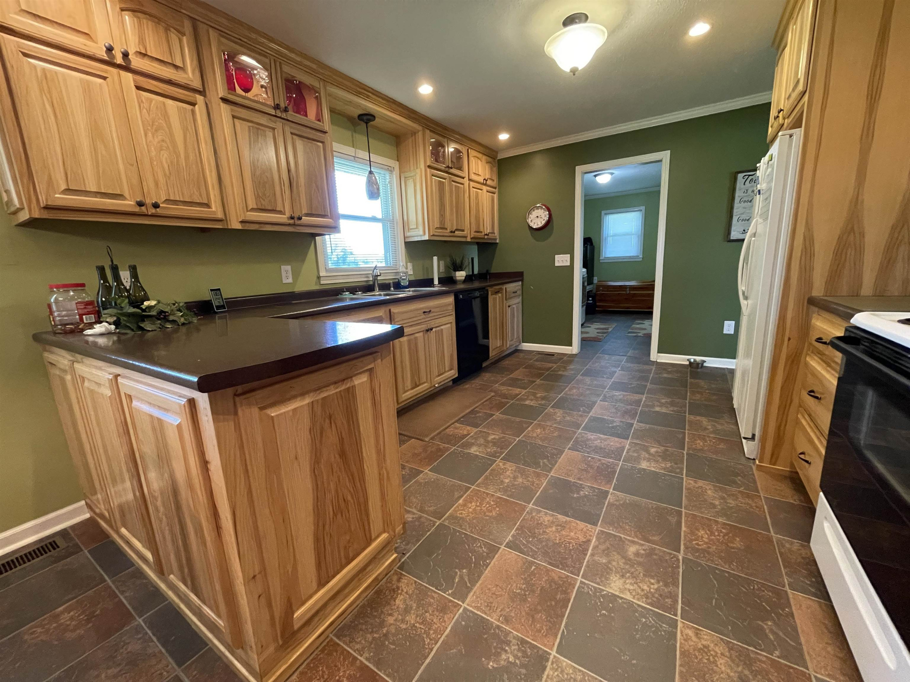 2507 East Grove Road Gleason, TN 38229 - Photo 3 of 37 a kitchen with granite countertop a stove a sink a refrigerator and cabinets