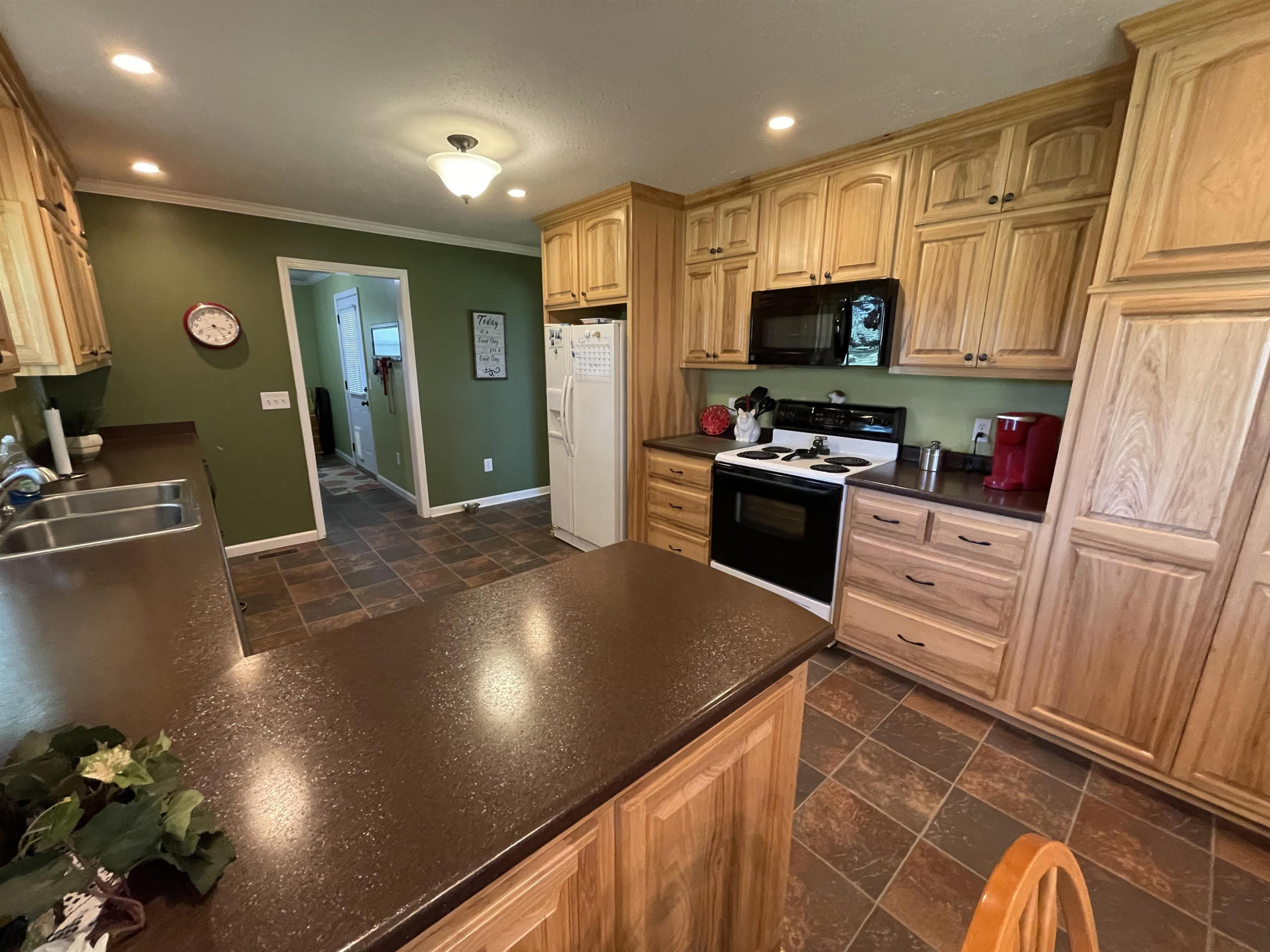 2507 East Grove Road Gleason, TN 38229 - Photo 4 of 37 a kitchen with granite countertop a sink stove and refrigerator
