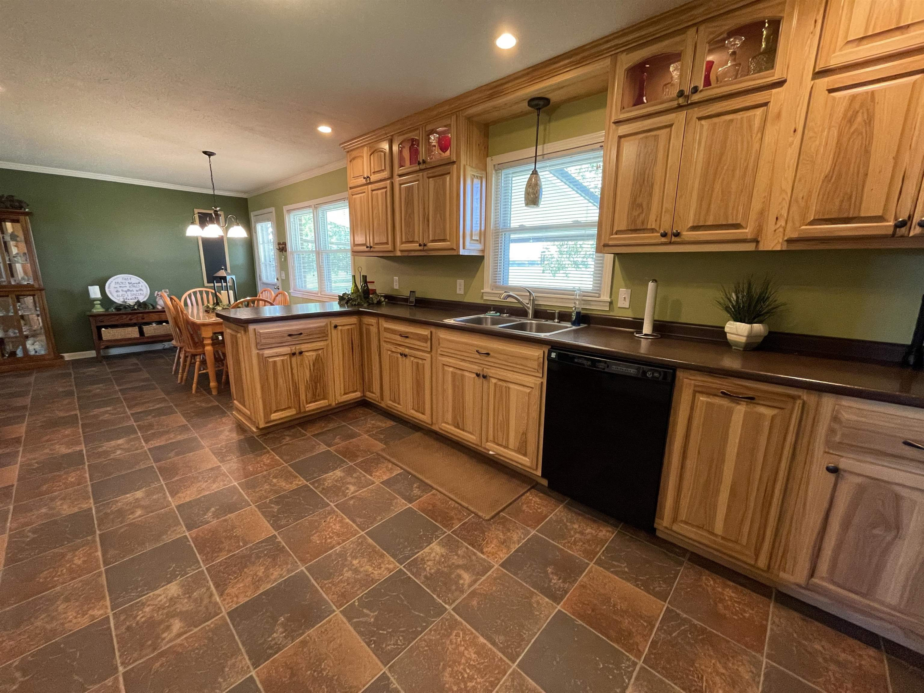 2507 East Grove Road Gleason, TN 38229 - Photo 5 of 37 a kitchen with stainless steel appliances granite countertop a sink a stove a microwave cabinets and a dining table