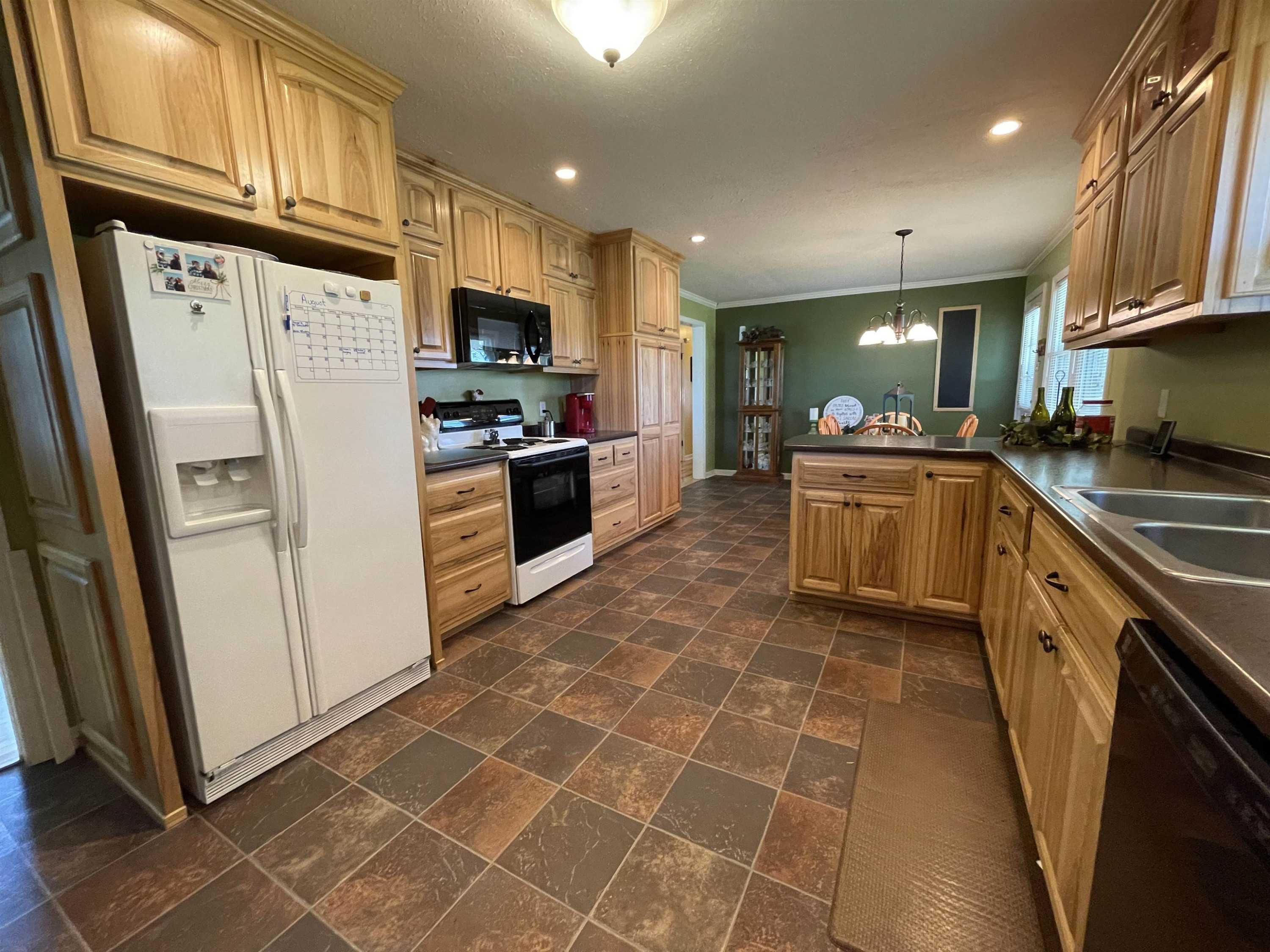 2507 East Grove Road Gleason, TN 38229 - Photo 6 of 37 a kitchen with stainless steel appliances granite countertop a refrigerator stove top oven and sink