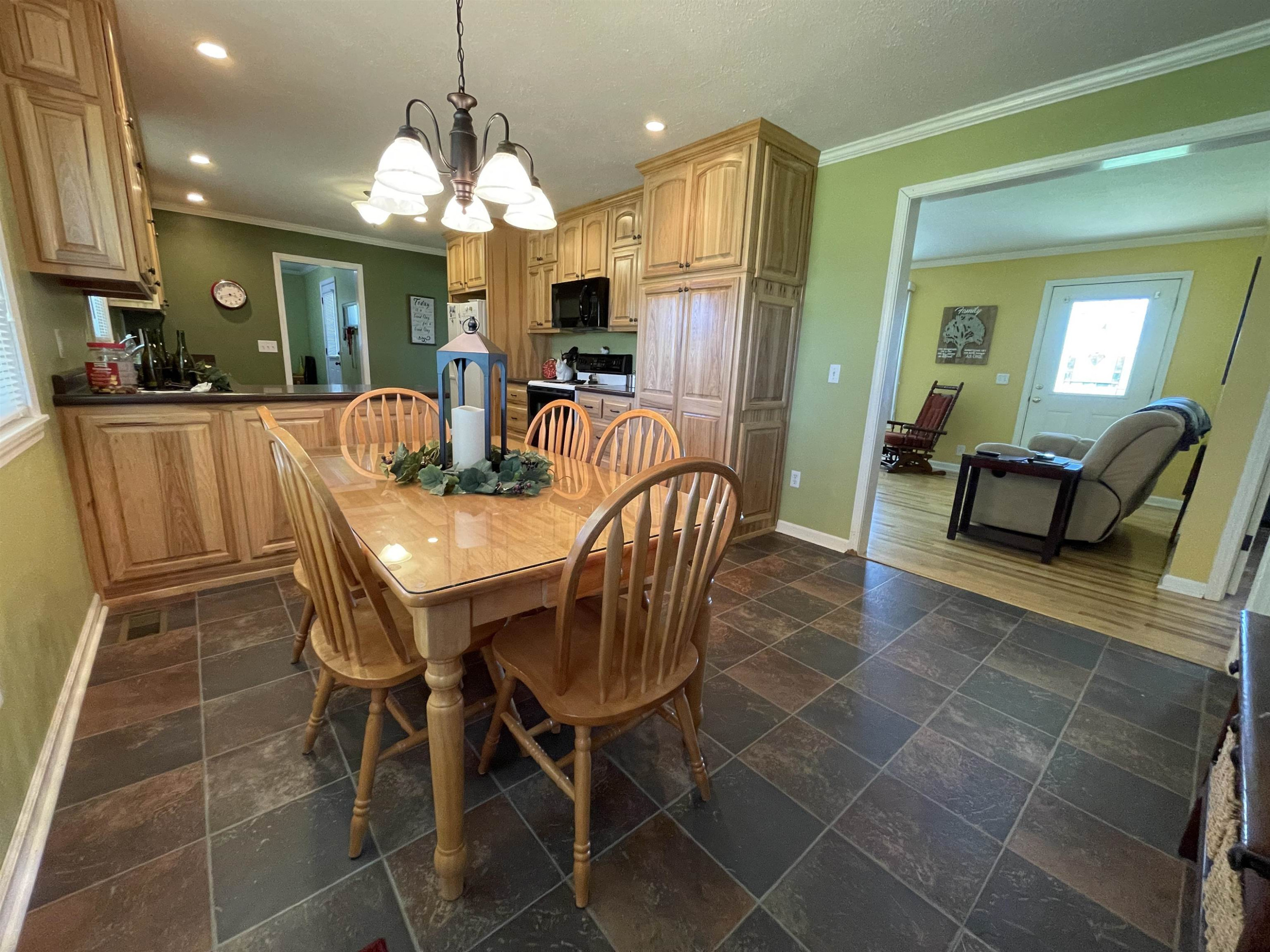 2507 East Grove Road Gleason, TN 38229 - Photo 7 of 37 a view of a dining room with furniture and a chandelier
