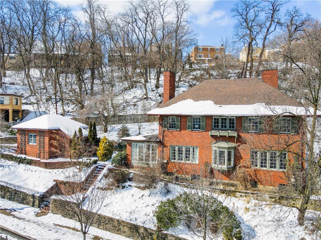 a view of a house with a yard covered with snow in the backyard