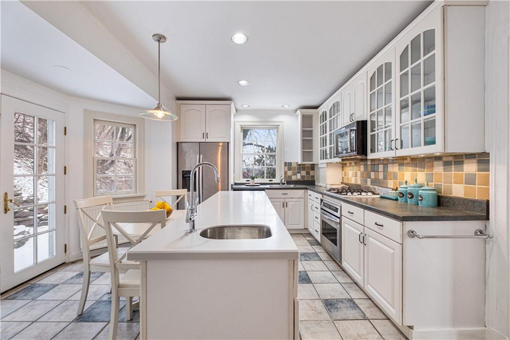 4305 Centre Pittsburgh, PA 15213 - Photo 16 of 47 a kitchen that has a lot of white cabinets and stainless steel appliances