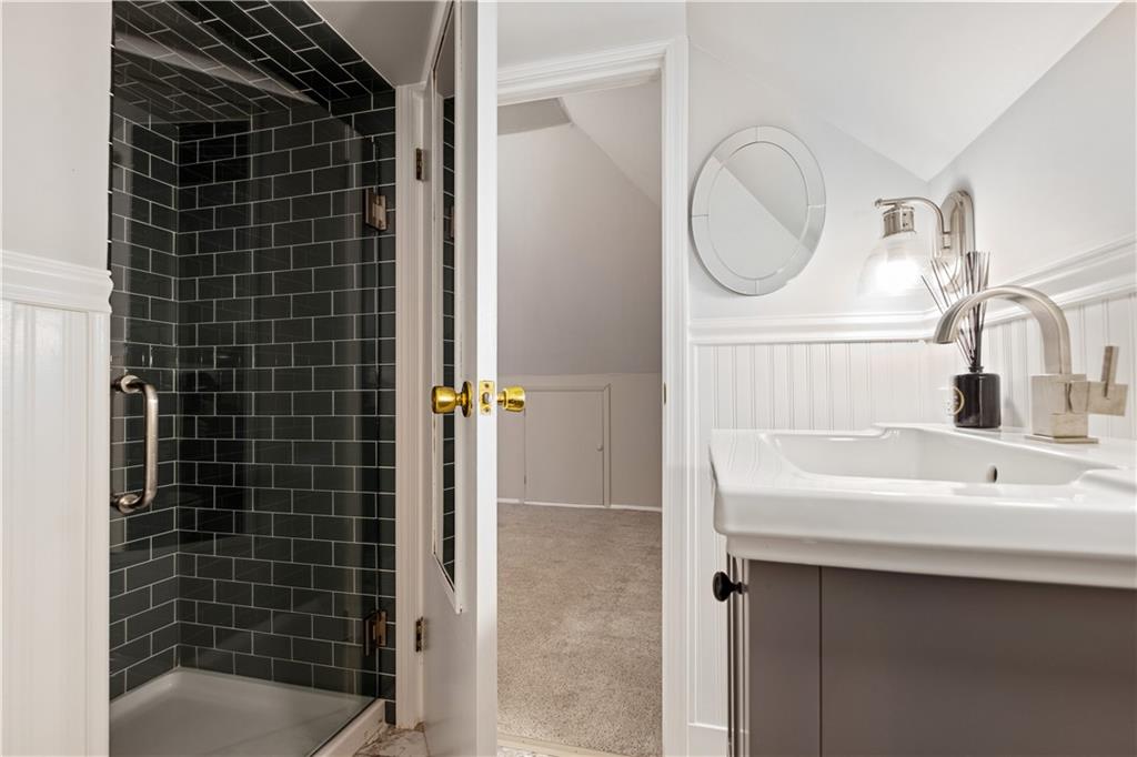 4305 Centre Pittsburgh, PA 15213 - Photo 35 of 47 a bathroom with a sink a mirror and a shower