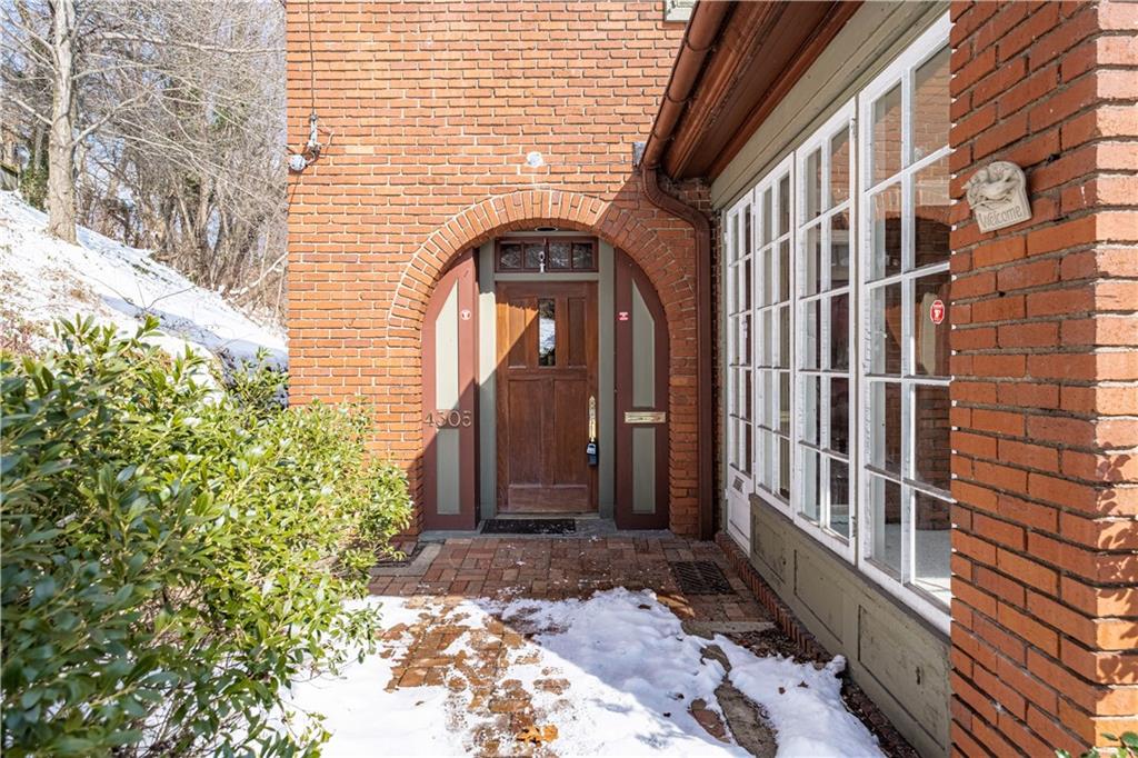 4305 Centre Pittsburgh, PA 15213 - Photo 5 of 47 a view of a brick house with a large windows and flower plants