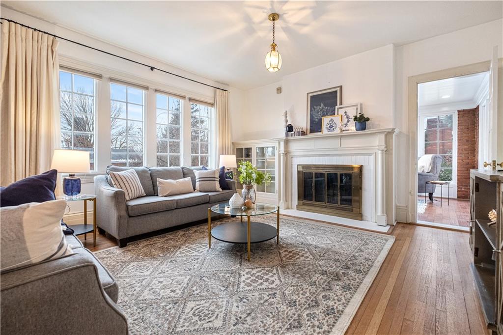 4305 Centre Pittsburgh, PA 15213 - Photo 8 of 47 a living room with furniture a large window and a fireplace