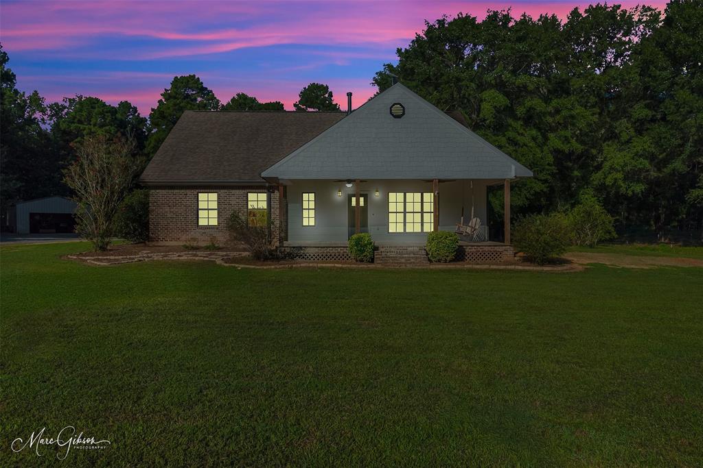 550 Linton Bellevue Road Benton, LA 71006 - Photo 36 of 37 View of front facade featuring covered porch, a front yard, roof with shingles, and brick siding