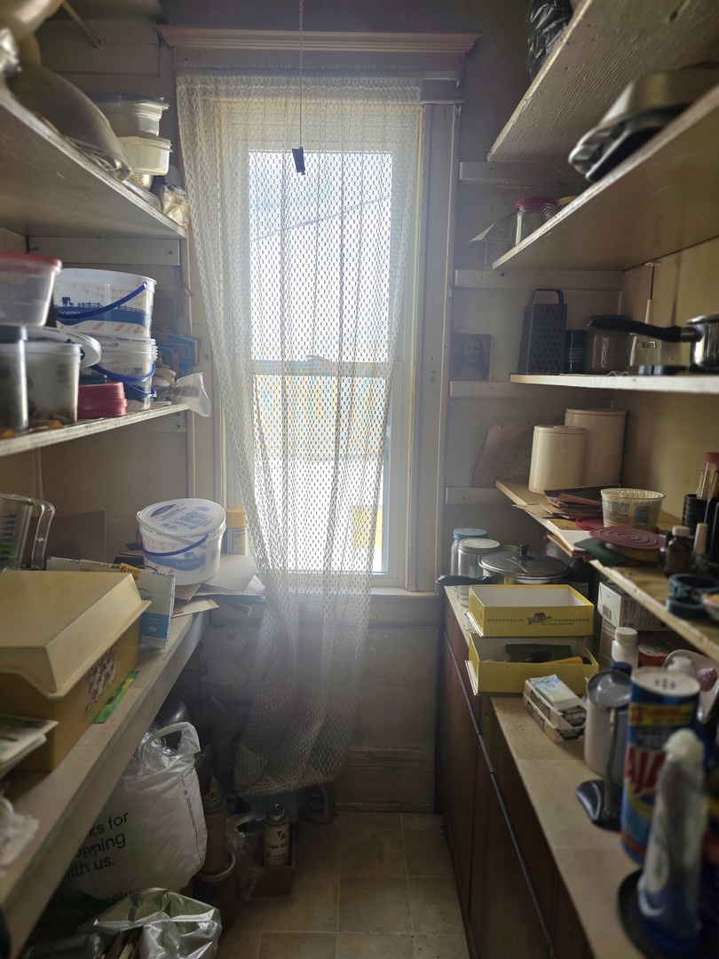 157-159 West Hickory Street Kankakee, IL 60901 - Photo 23 of 33 a room with a chair and appliances