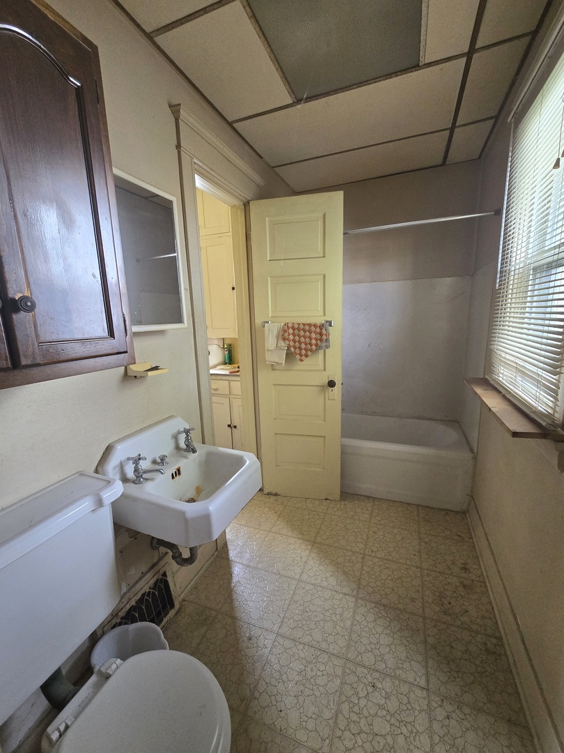 157-159 West Hickory Street Kankakee, IL 60901 - Photo 9 of 33 a bathroom with a sink toilet and shower