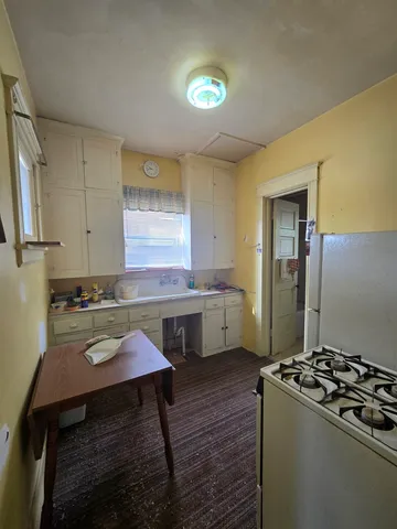 a kitchen with a stove and a sink