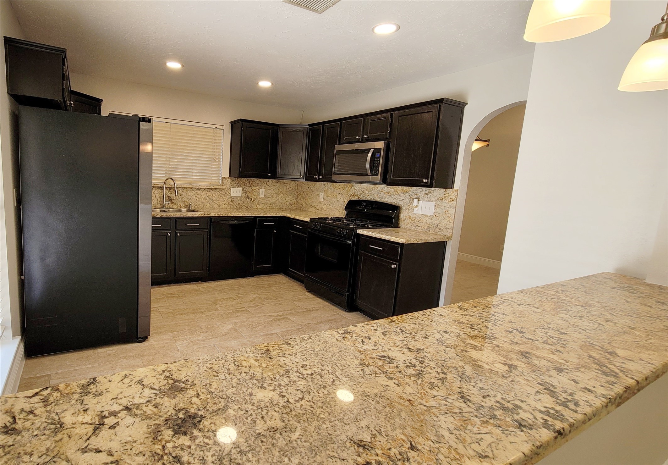 5227 Clarkston Lane Spring, TX 77379 - Photo 10 of 28 Bar seating through the kitchen and living room