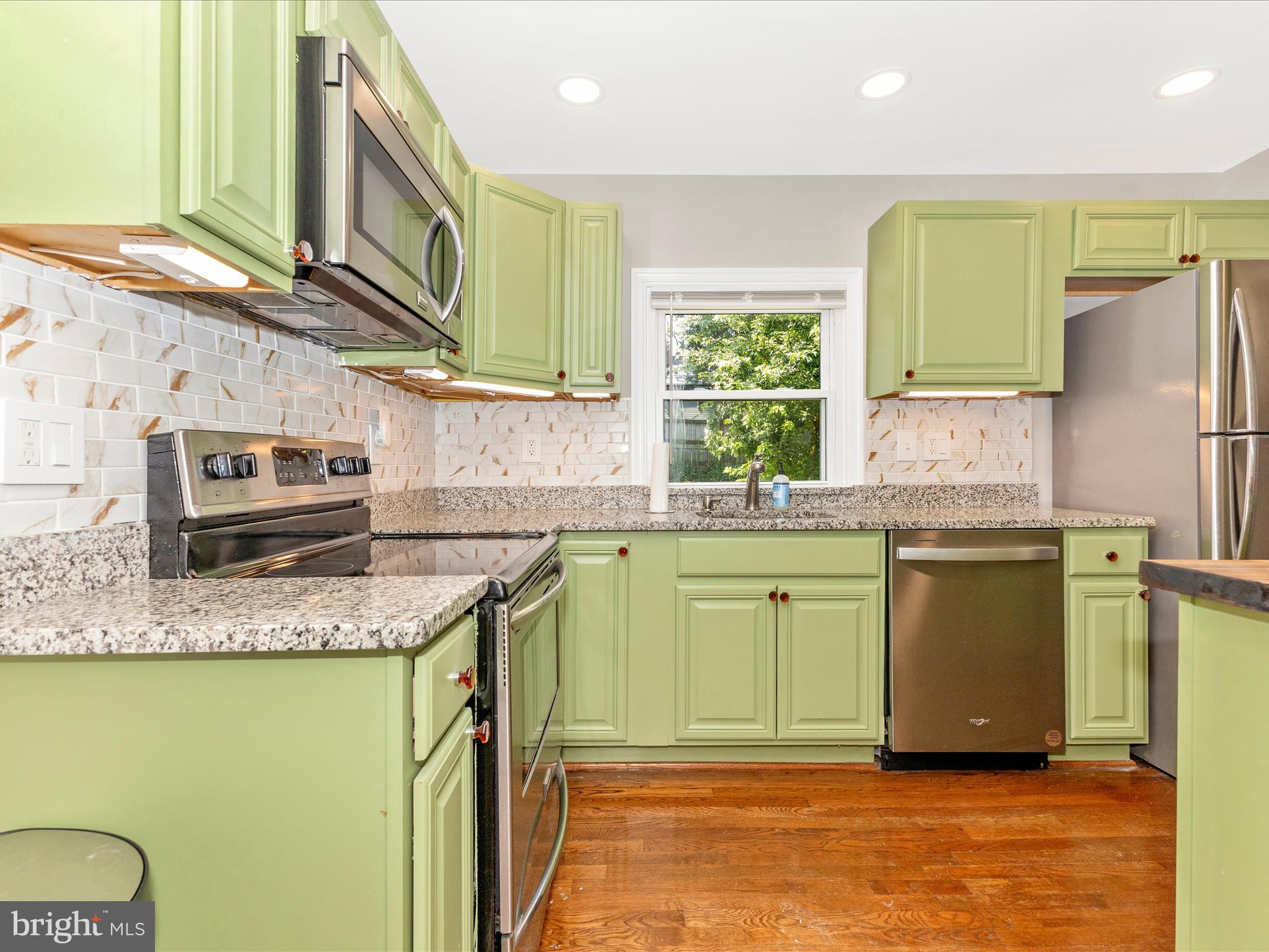 12230 Selfridge Road Silver Spring, MD 20906 - Photo 12 of 49 a kitchen with sink refrigerator and microwave