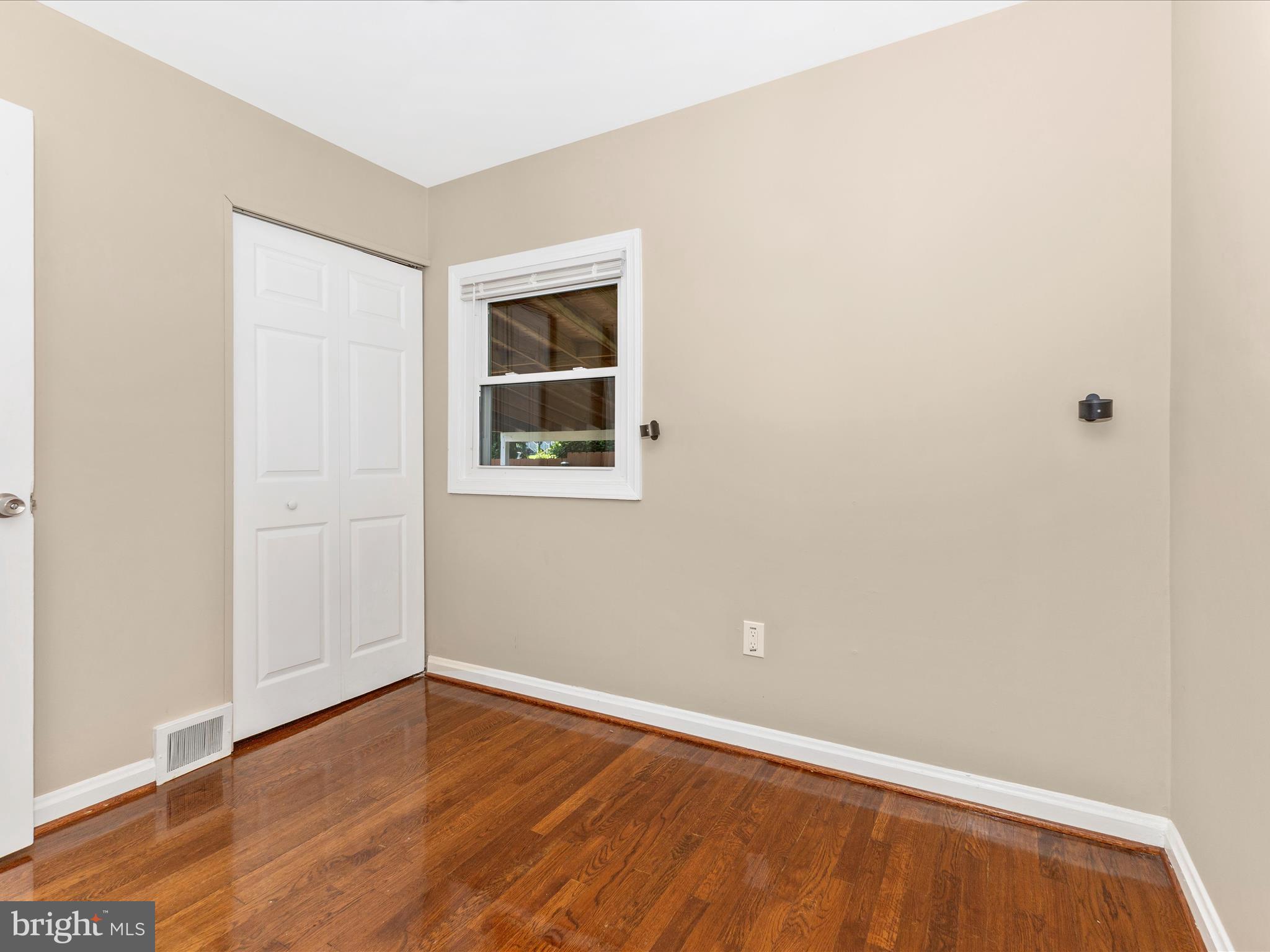 12230 Selfridge Road Silver Spring, MD 20906 - Photo 29 of 49 a view of an empty room with wooden floor and a window