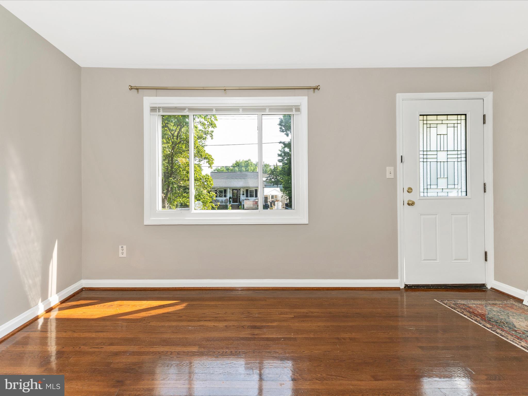 12230 Selfridge Road Silver Spring, MD 20906 - Photo 3 of 49 a view of empty room with window and wooden floor