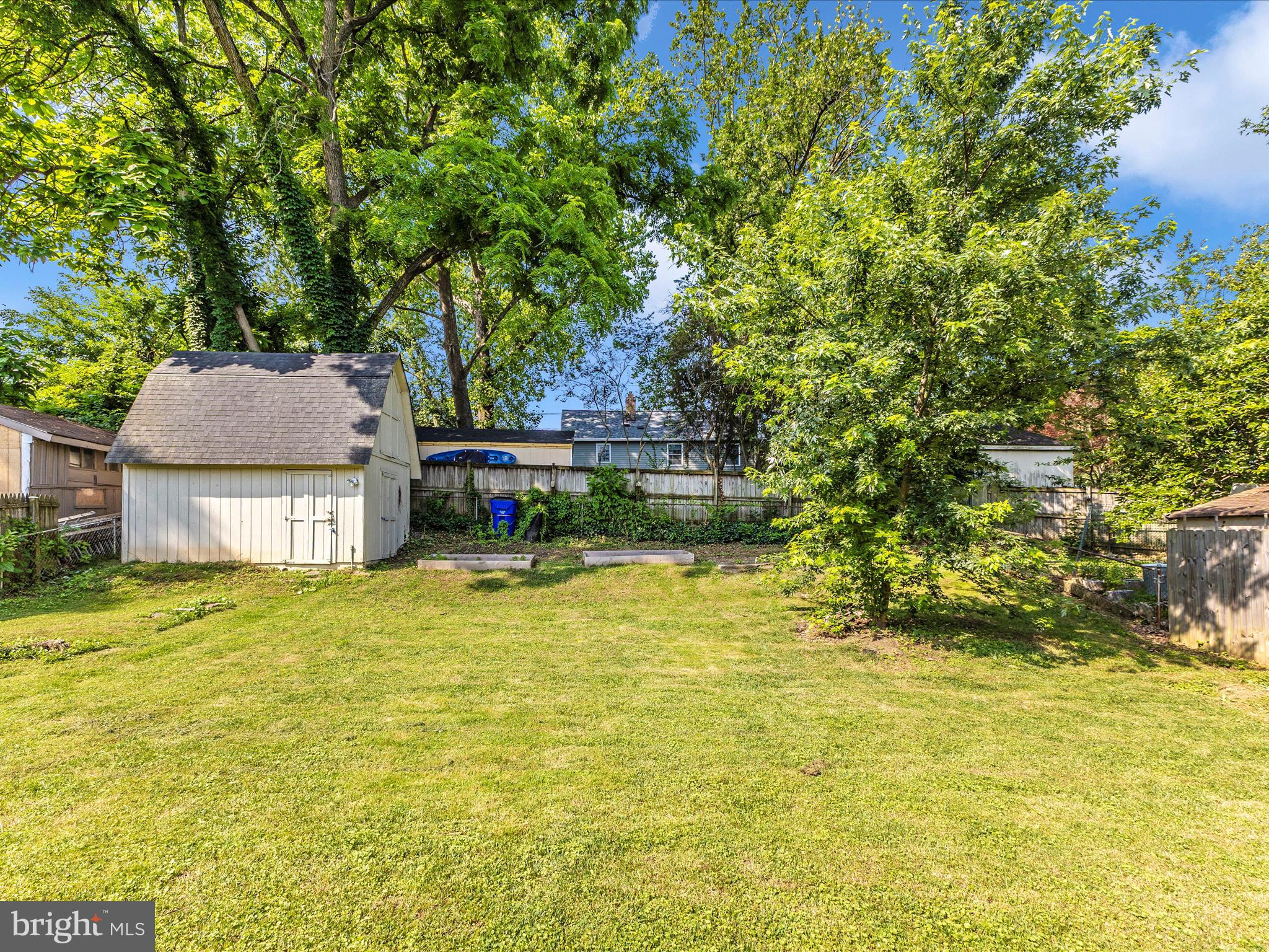 12230 Selfridge Road Silver Spring, MD 20906 - Photo 44 of 49 a backyard of a house with a garden and tree