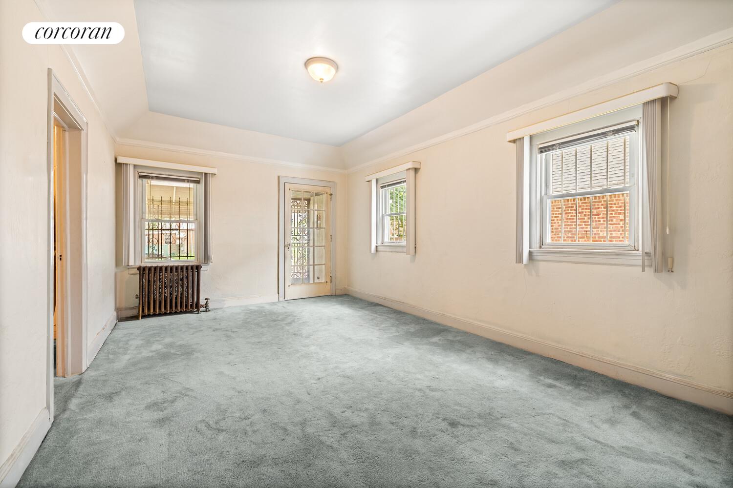 187-23 Brinkerhoff Avenue Queens, NY 11412 - Photo 3 of 10 an empty room with windows