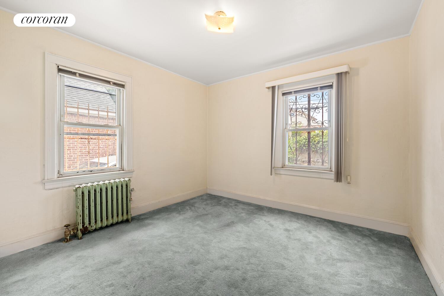 187-23 Brinkerhoff Avenue Queens, NY 11412 - Photo 7 of 10 an empty room with windows