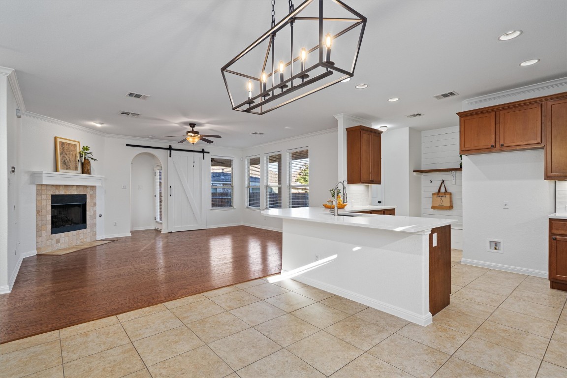 422 Village Commons Boulevard Georgetown, TX 78633 - Photo 14 of 40 a large kitchen with stainless steel appliances granite countertop a stove and cabinets