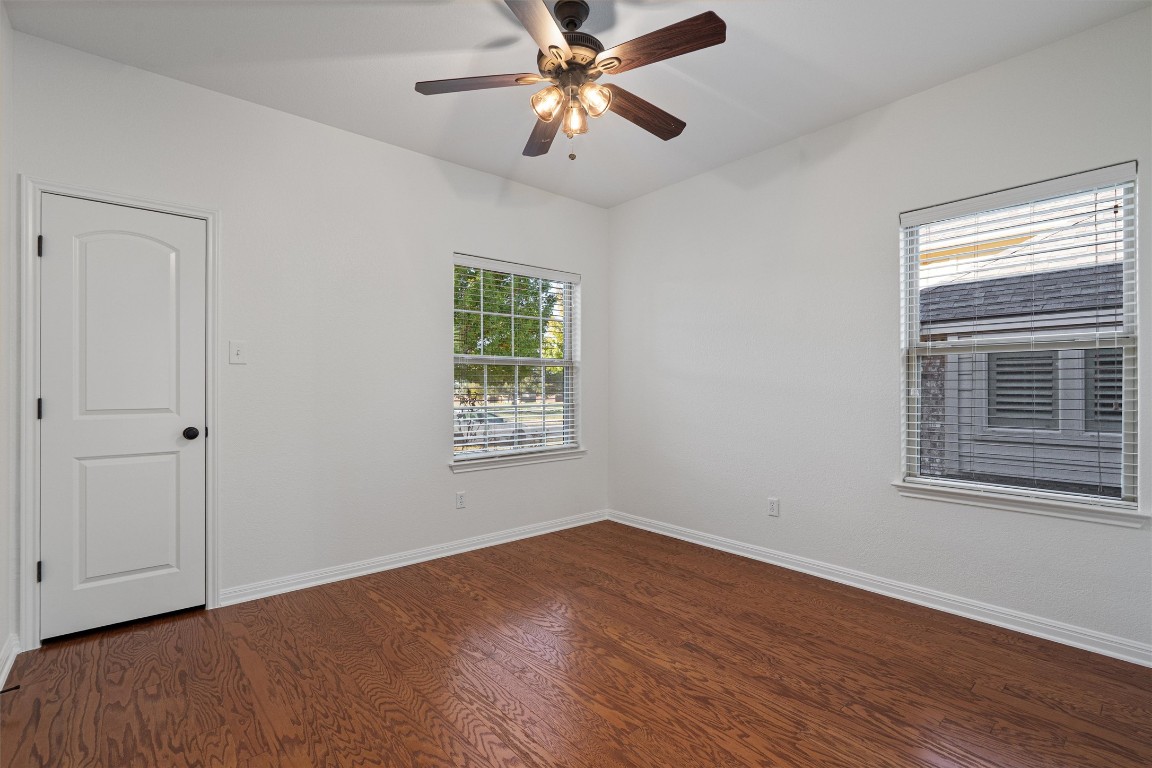 422 Village Commons Boulevard Georgetown, TX 78633 - Photo 18 of 40 a view of an empty room with window and wooden floor