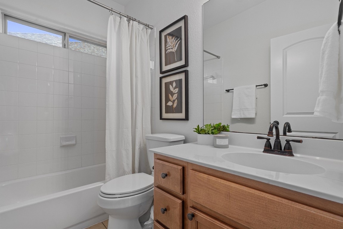422 Village Commons Boulevard Georgetown, TX 78633 - Photo 20 of 40 a bathroom with a sink a toilet and shower