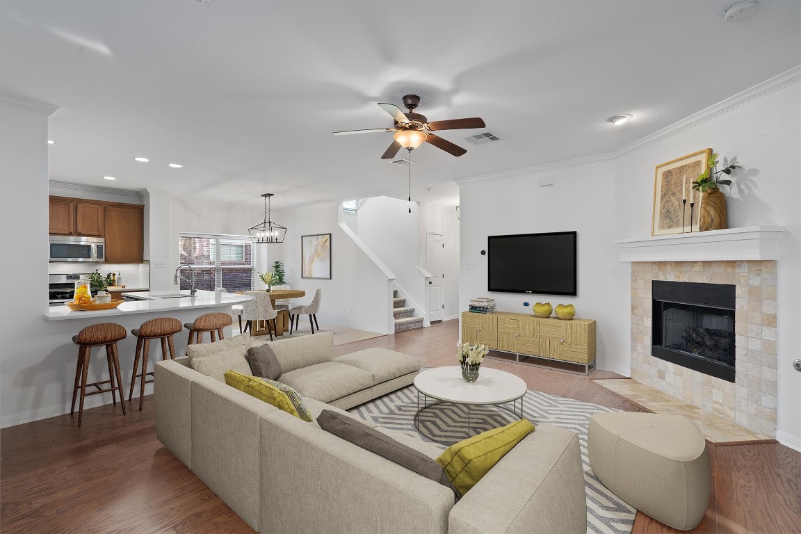 422 Village Commons Boulevard Georgetown, TX 78633 - Photo 2 of 40 a living room with furniture kitchen view and a fireplace
