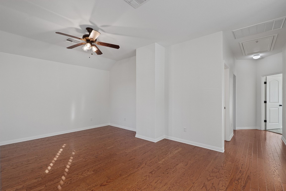 422 Village Commons Boulevard Georgetown, TX 78633 - Photo 22 of 40 a view of empty room with wooden floor and fan