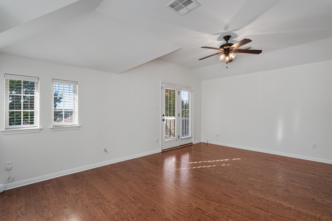422 Village Commons Boulevard Georgetown, TX 78633 - Photo 23 of 40 a view of empty room with wooden floor and fan