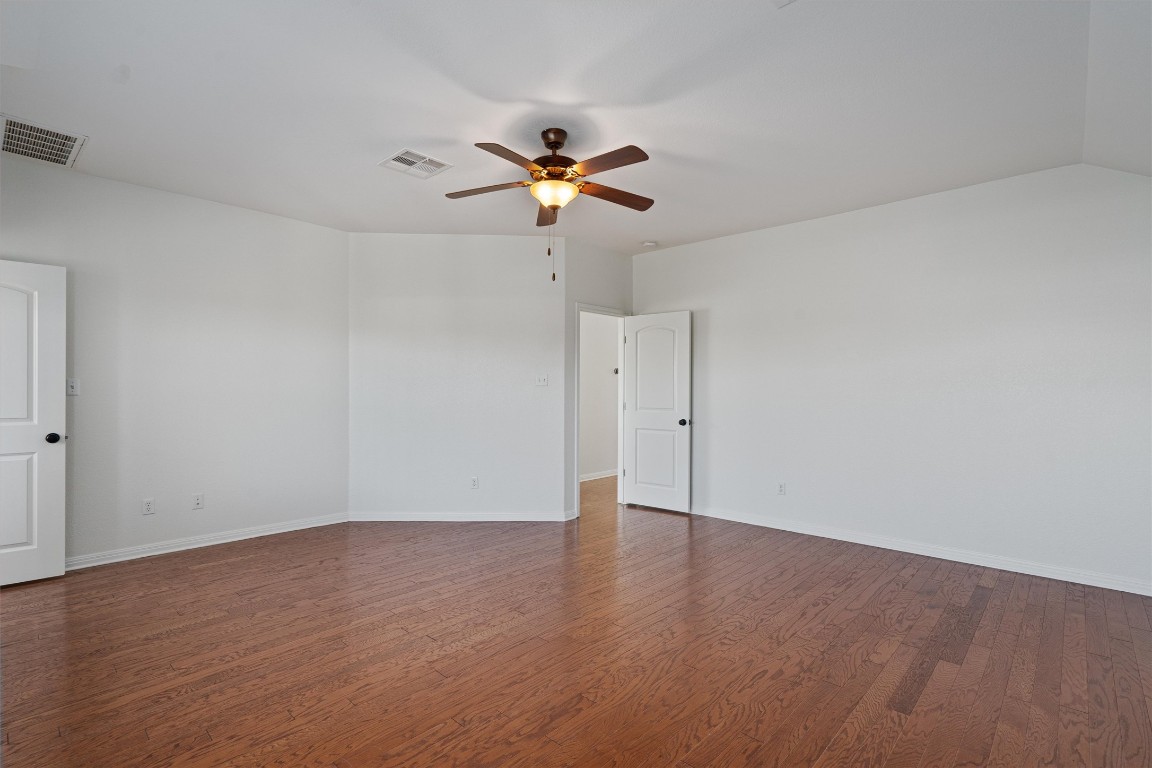 422 Village Commons Boulevard Georgetown, TX 78633 - Photo 25 of 40 a view of a room with wooden floor and a ceiling fan