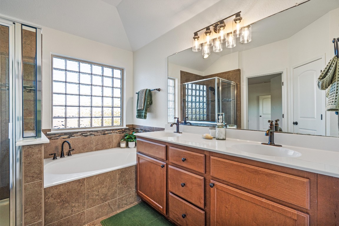 422 Village Commons Boulevard Georgetown, TX 78633 - Photo 28 of 40 a spacious bathroom with a granite countertop sink mirror and bathtub
