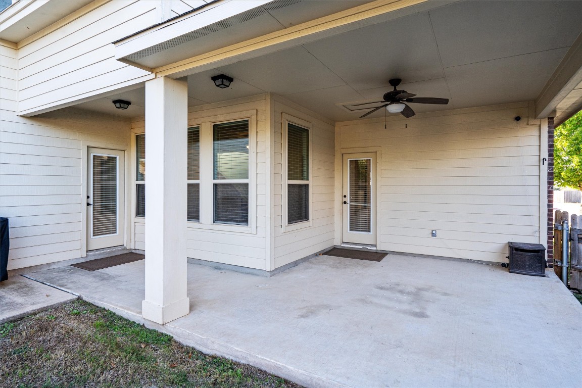 422 Village Commons Boulevard Georgetown, TX 78633 - Photo 33 of 40 a view of a house with a ceiling fan and floor to ceiling window
