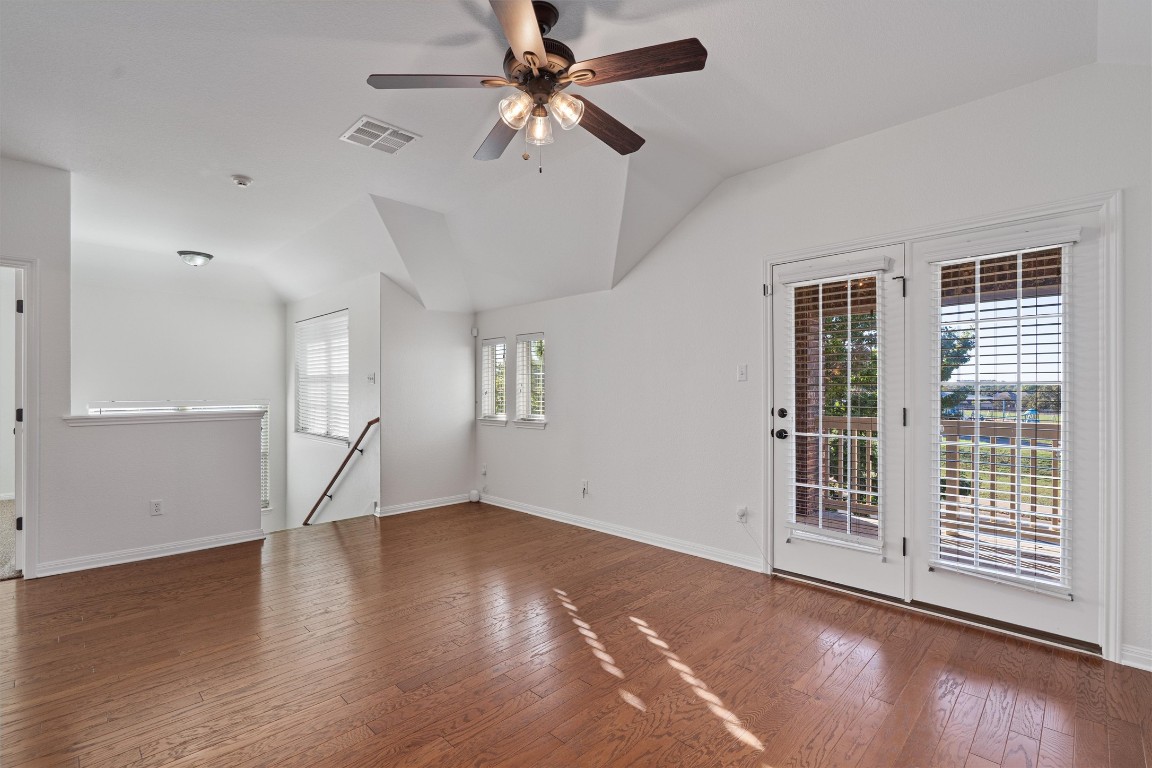422 Village Commons Boulevard Georgetown, TX 78633 - Photo 6 of 40 wooden floor in an empty room with a window