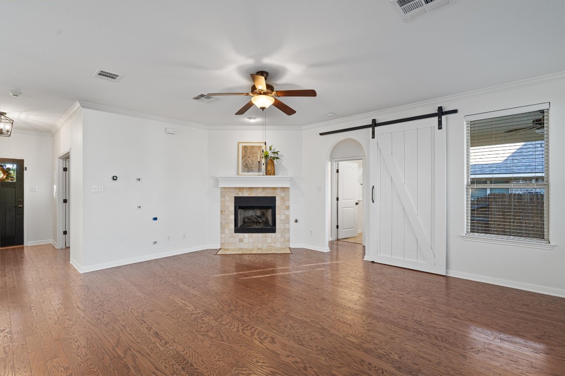 422 Village Commons Boulevard Georgetown, TX 78633 - Photo 10 of 40 an empty room with windows and a fireplace