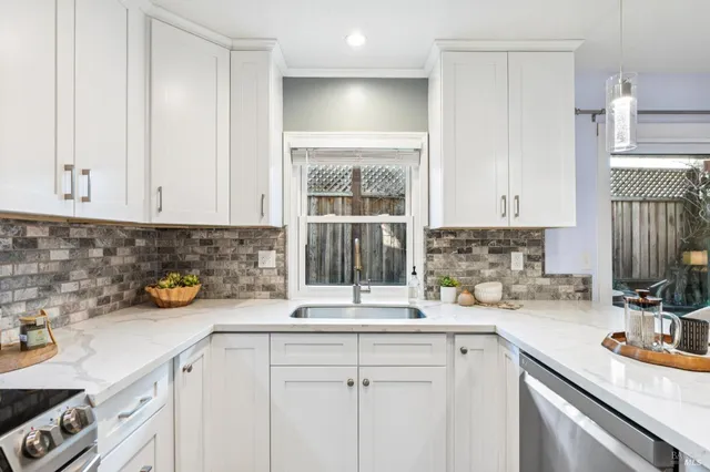 a kitchen with a sink and a stove top oven