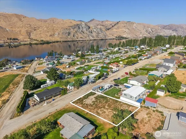 an aerial view of residential houses with outdoor space and river
