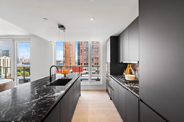 a kitchen with stainless steel appliances granite countertop sink stove and cabinets