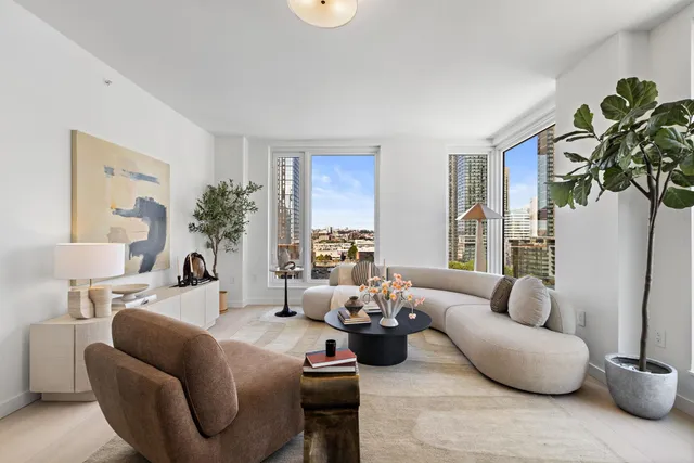 a living room with furniture and a potted plant