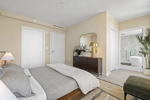 a bedroom with a bed and a lamp on table