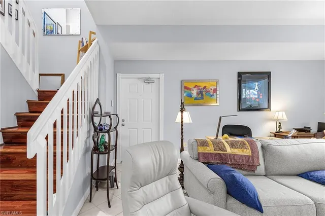a living room with furniture and stairs